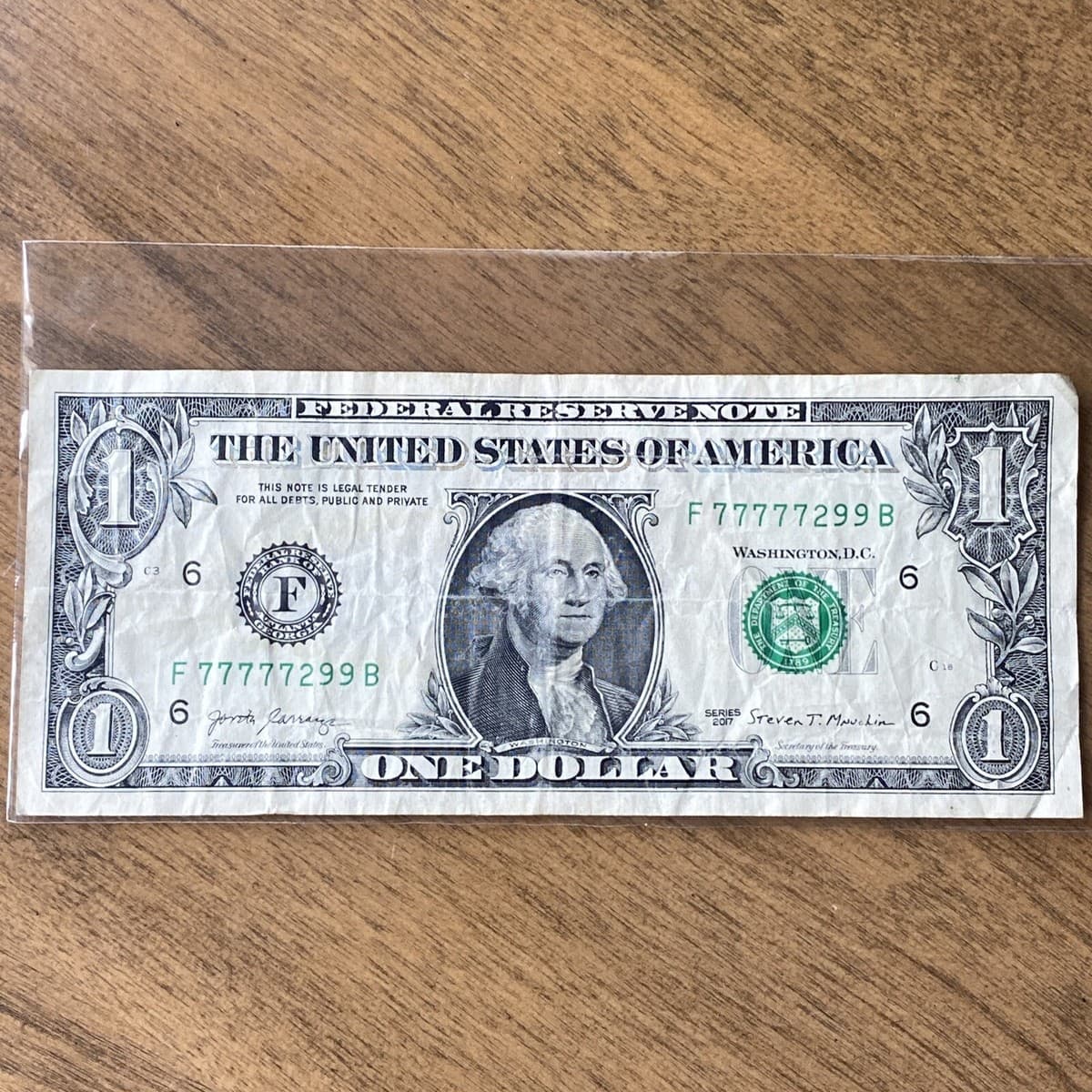 Five of a Kind dollar bill with serial 77777299